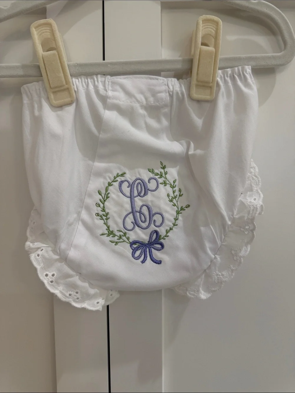 Pair of IC COLLECTIONS White Ruffle Diaper Covers w/ “C” Floral Monograms